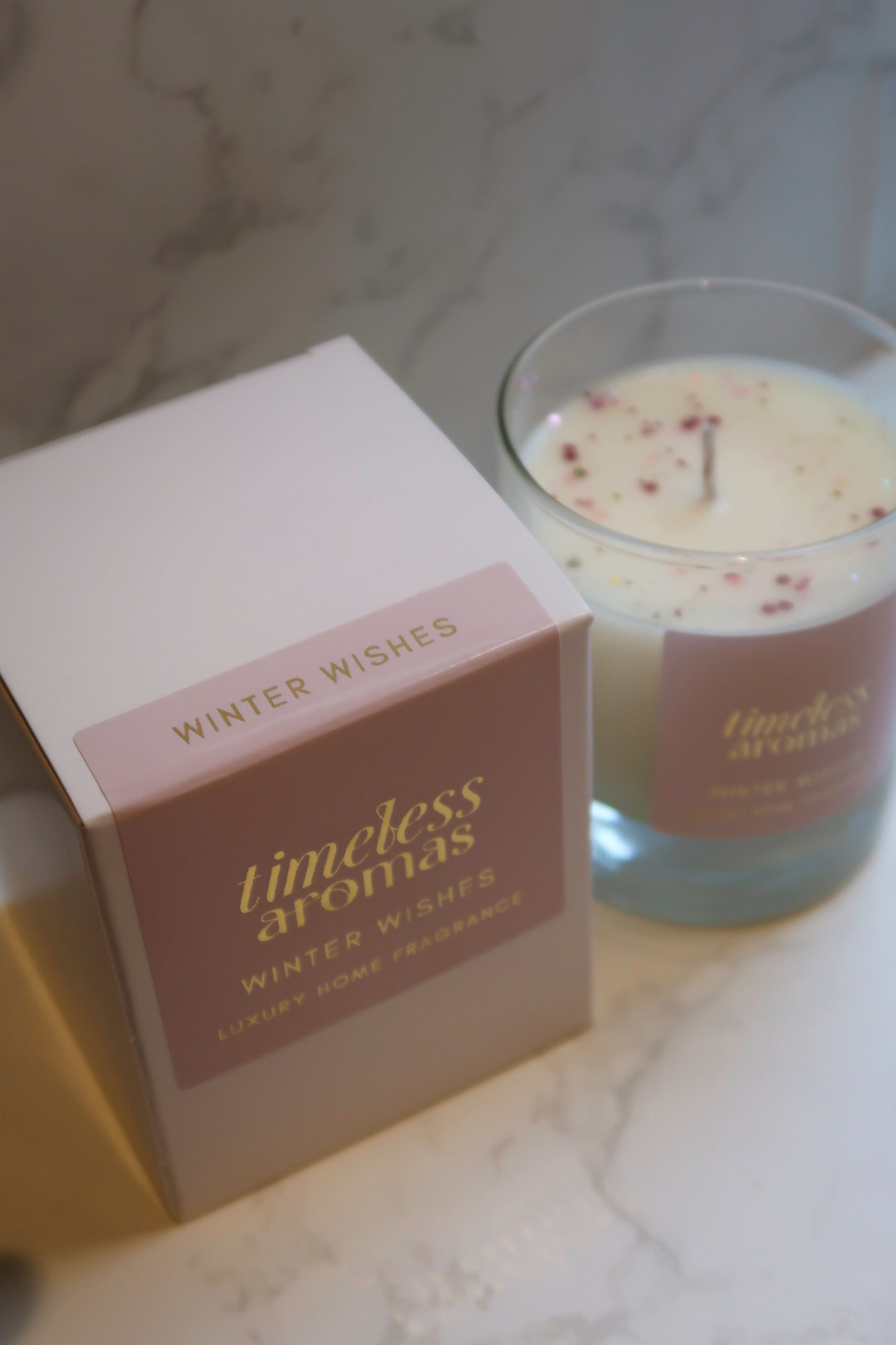 Timeless Aromas Winter Wishes luxury scented candle with its stylish packaging, perfect for gifting or personal use.
