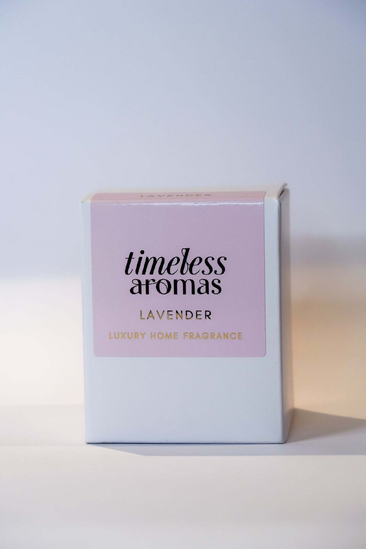 Stylish packaging of the Lavender Luxury Scented Candle by Timeless Aromas, presented in a pastel pink box, perfect for gifting.