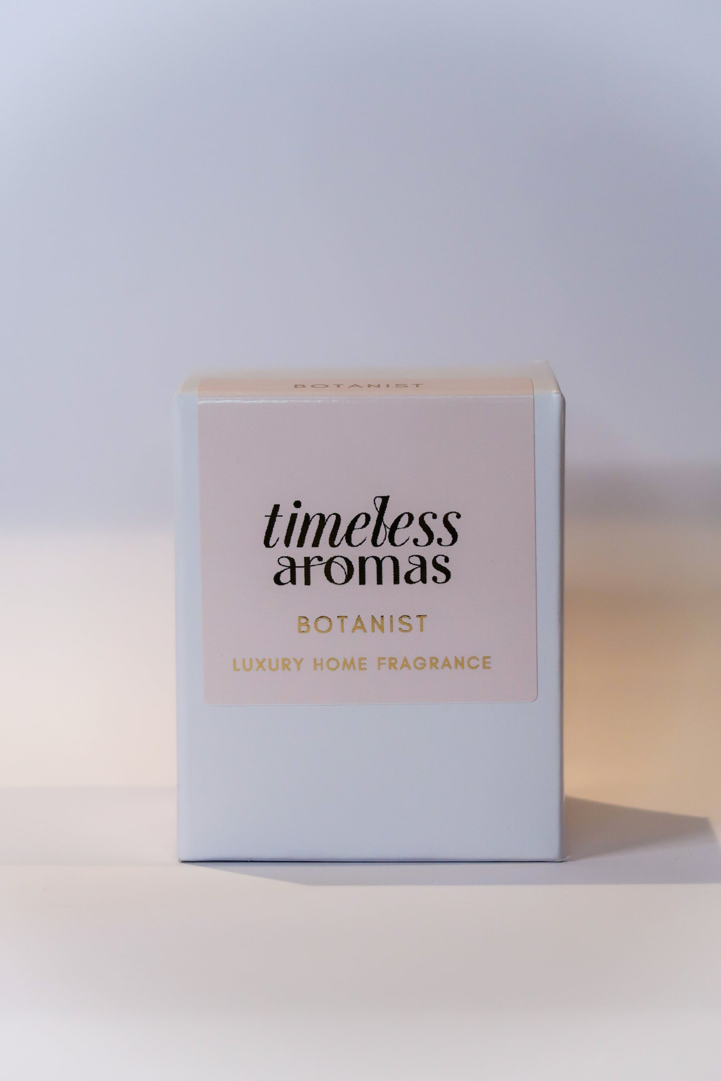 The stylish packaging of Timeless Aromas Botanist Handcrafted Luxury Candle, designed for gifting or personal use, embodies luxury home fragrance.