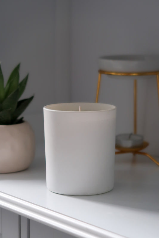 An unlit 30cl White Matte Candle from Timeless Aromas Ltd, part of a stylish pack of 6 hand poured candles made for gifting or enhancing home fragrance. This matte ceramic jar candle is perfect for clean, elegant decor. Blank label candles for businesses