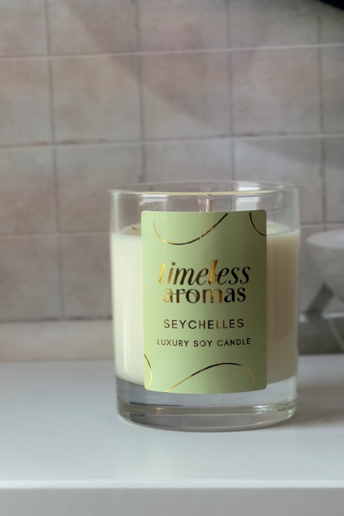 Close-up view of the Seychelles Luxury Soy Candle by Timeless Aromas, highlighting its elegant packaging and the inviting wax, perfect representation of a seychelles luxury scented candle for home decor.