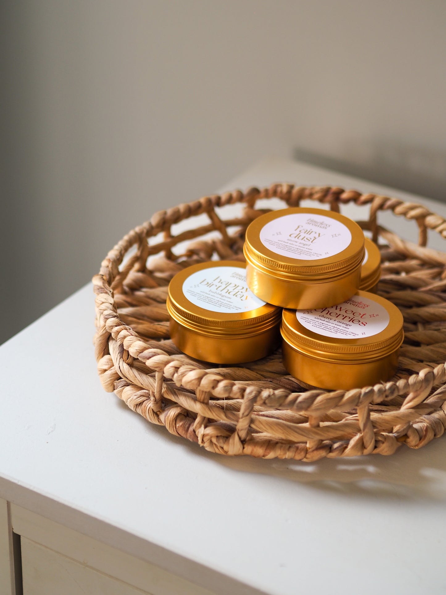 Happy Birthday Gold Tin Bath Salts by Timeless Aromas displayed in a lovely basket, emphasising the joyful experience of these bath salts for relaxation.