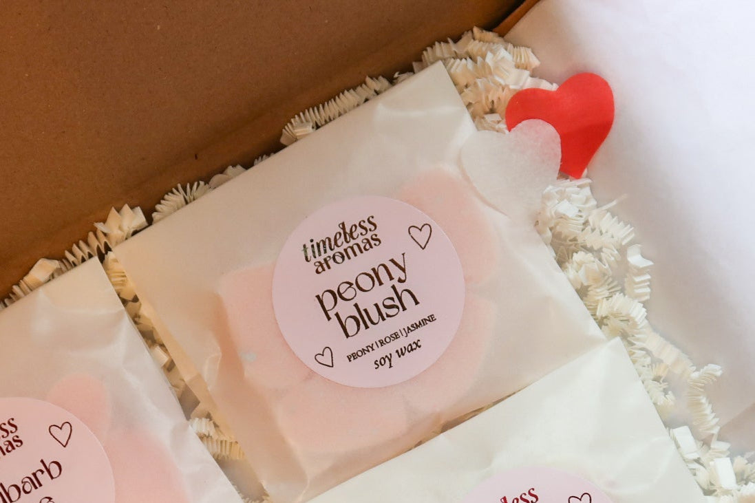 Close-up of Timeless Aromas Peony Blush soy wax melt from the Pink Wax Melt Gift Set, highlighted with delicate heart-shaped designs and stylish packaging.