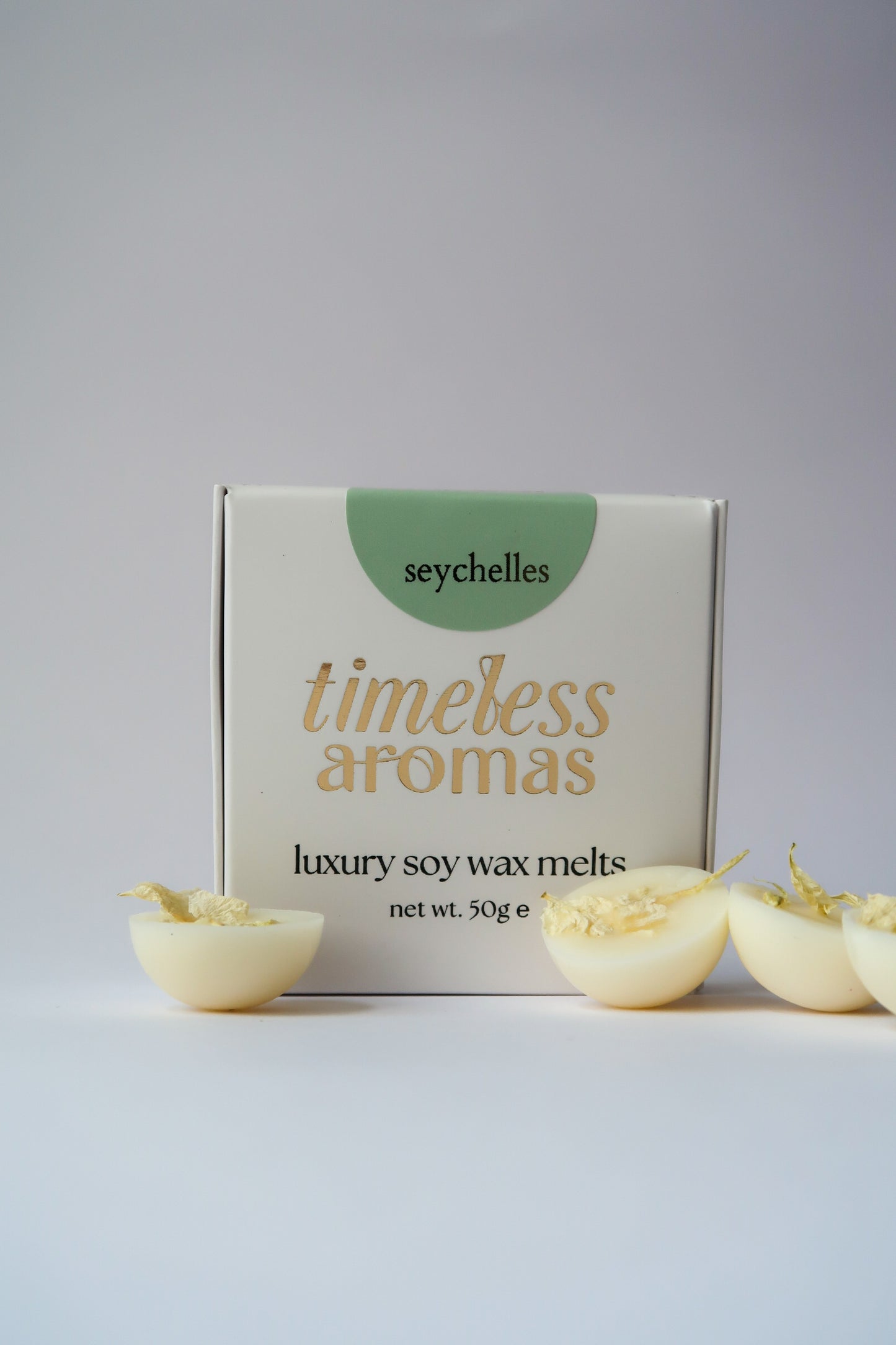 Seychelles luxury wax melts box from Timeless Aromas Ltd, featuring a beautifully designed packaging with the brand name and product details, accompanied by mini dome shapes of wax melts.