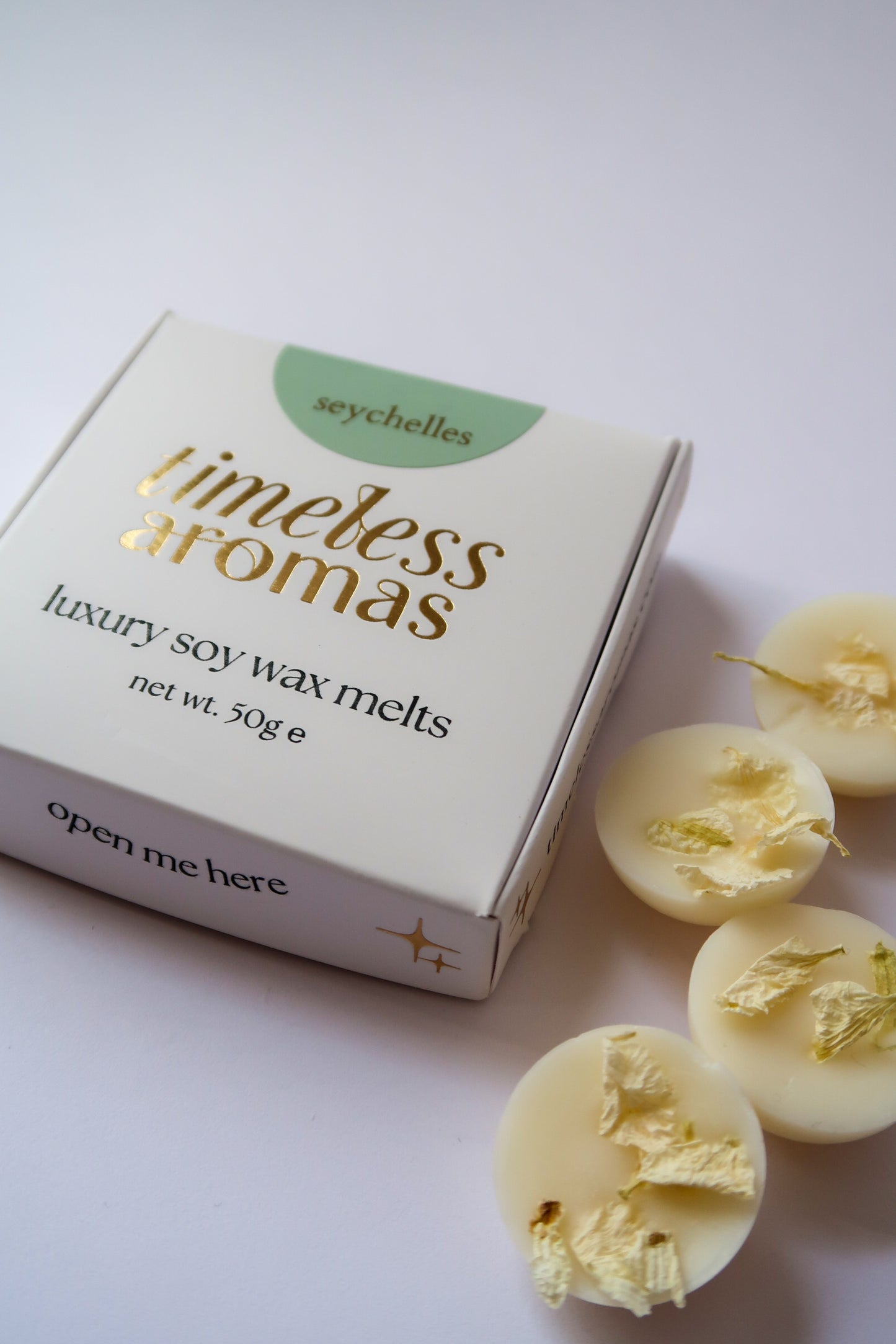 Seychelles luxury wax melts box from Timeless Aromas Ltd, featuring a beautifully designed packaging with the brand name and product details, accompanied by mini dome shapes of wax melts.