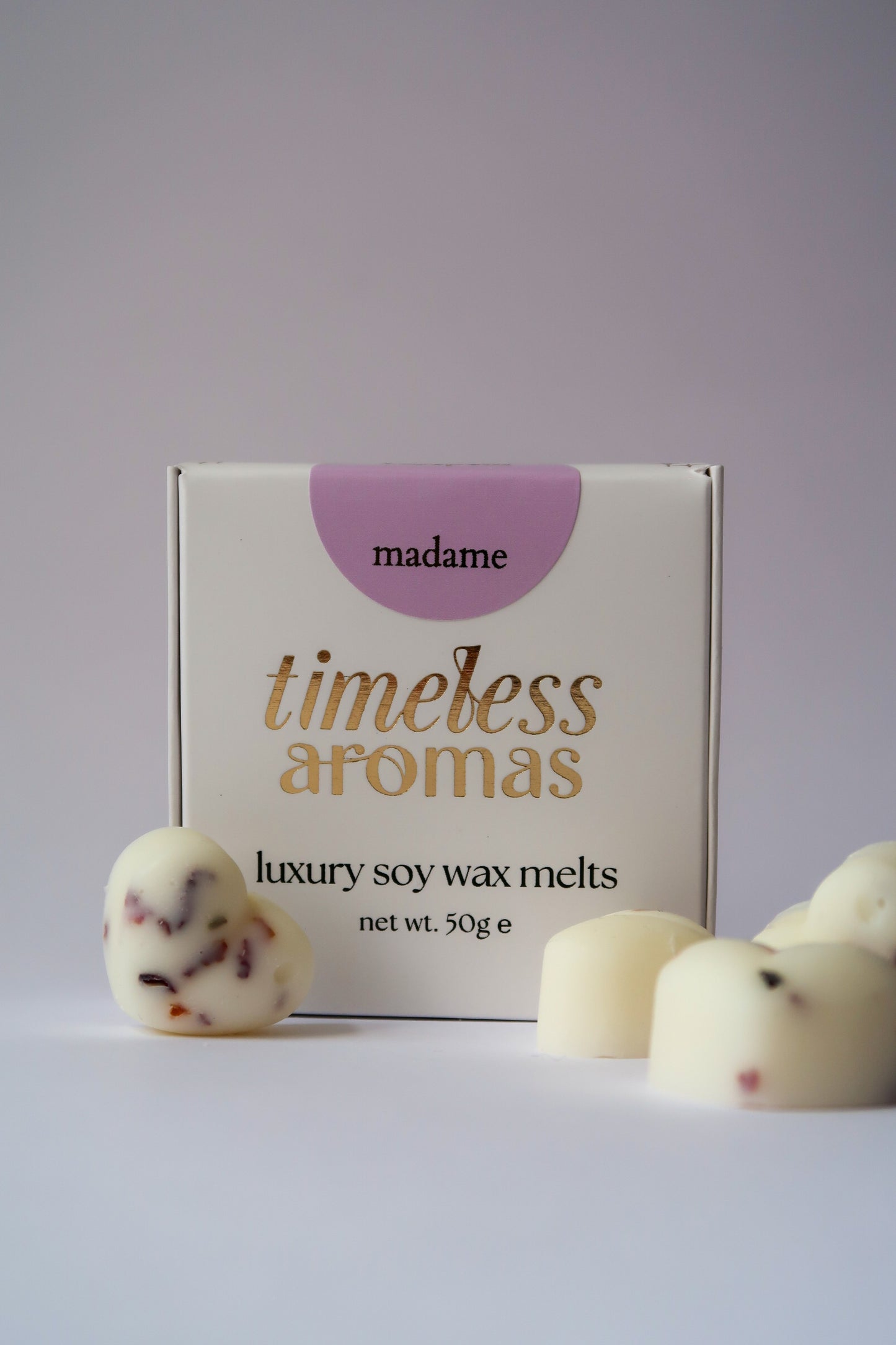 Madame Wax Melt Box featuring Timeless Aromas Ltd, showcasing white, botanical filled heart shaped wax melts with sparkling accents, ideal for filling your home with fragrance.