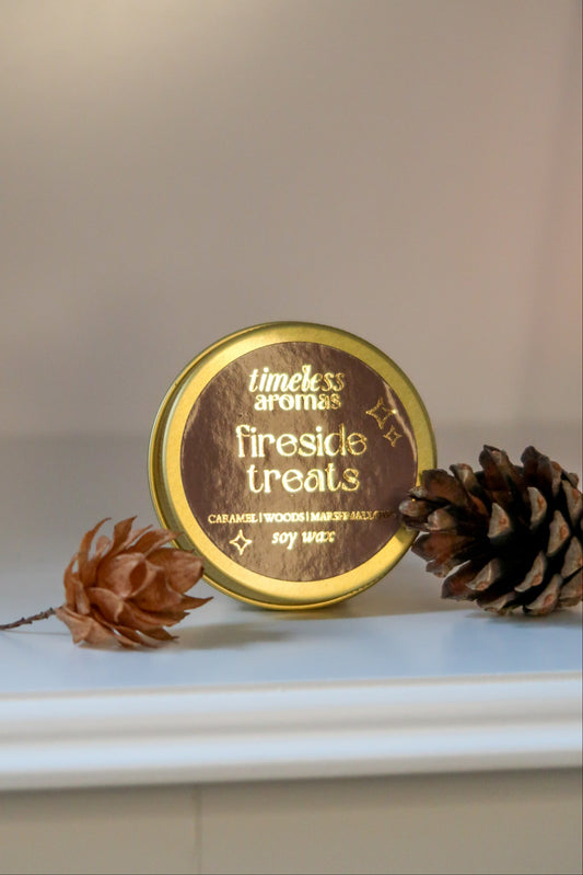 Luxury Gold Tin Candle by Timeless Aromas - Fireside Treats, featuring a gleaming gold screw-top with fragrant notes reminiscent of sweet caramel and smoky marshmallows.