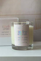 Indulge in the Sweetness of Our Birthday Cake Scented Candle, showcasing a luxurious soy candle in a glass jar with a stylish label, perfect for creating a warm and inviting aroma in your home.