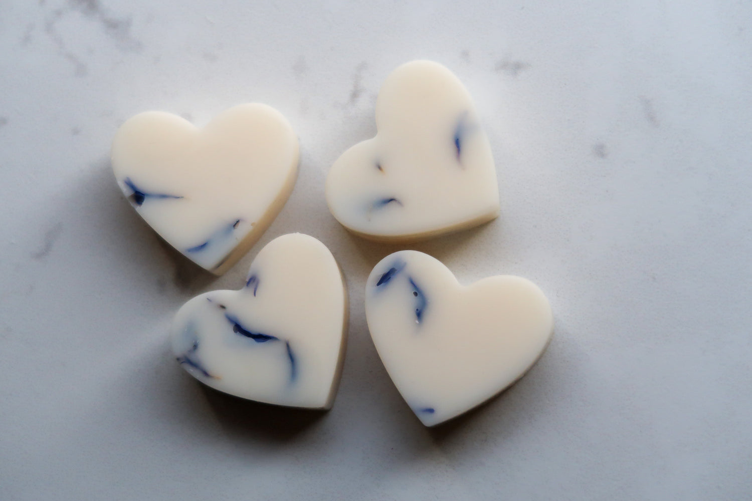 Sale Products featuring heart-shaped wax melts in a creamy color with blue swirls, perfect for clearance scented products lovers looking to stock up on their favorites.