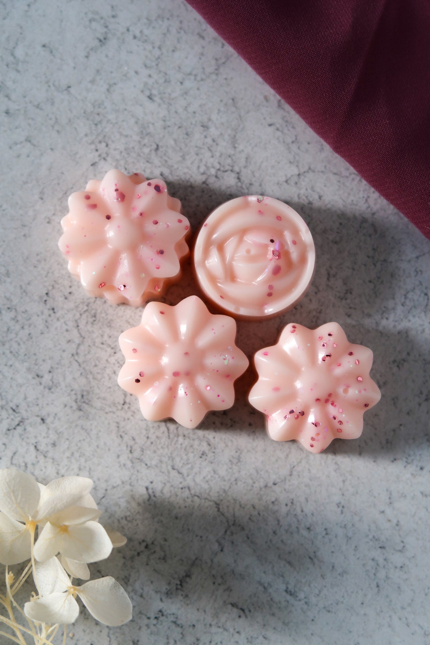 Beautifully crafted pink luxury wax melts arranged on a soft surface, perfect for enhancing your ambiance, from the Timeless Monthly Melts luxury wax melt subscription.