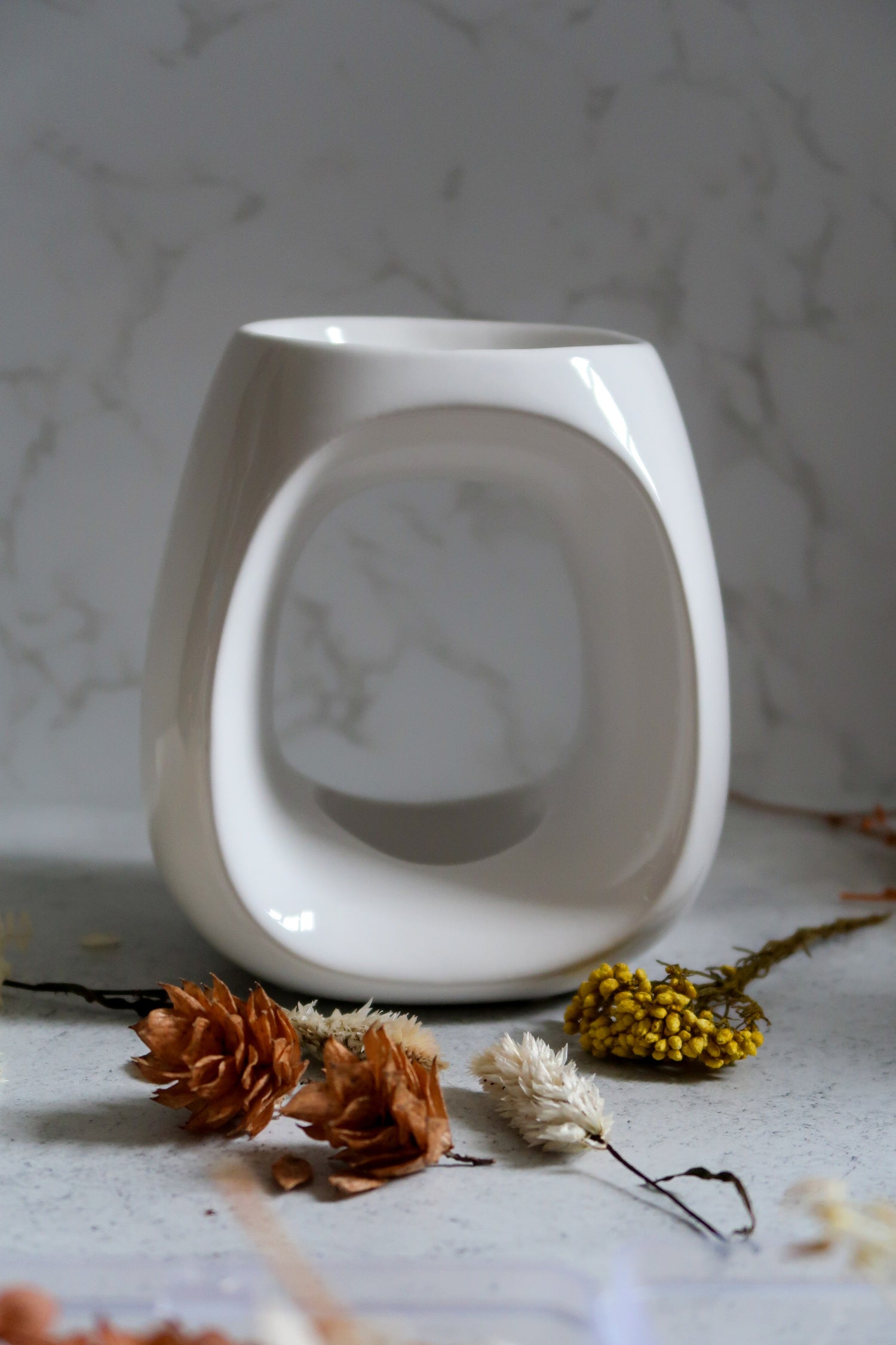 Stylish white wax melt burner, part of our Gifts + Accessories collection, perfect for creating a cozy atmosphere with home fragrance accessories.