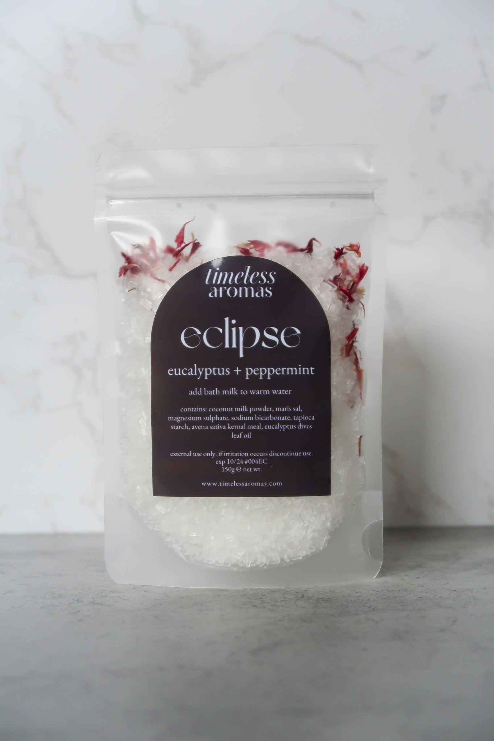 Timeless Aromas Eclipse Bath Milk featuring eucalyptus and peppermint essential oils, ideal for a relaxing soak with this vegan bath milk, beautifully packaged with floral accents and clear ingredients.
