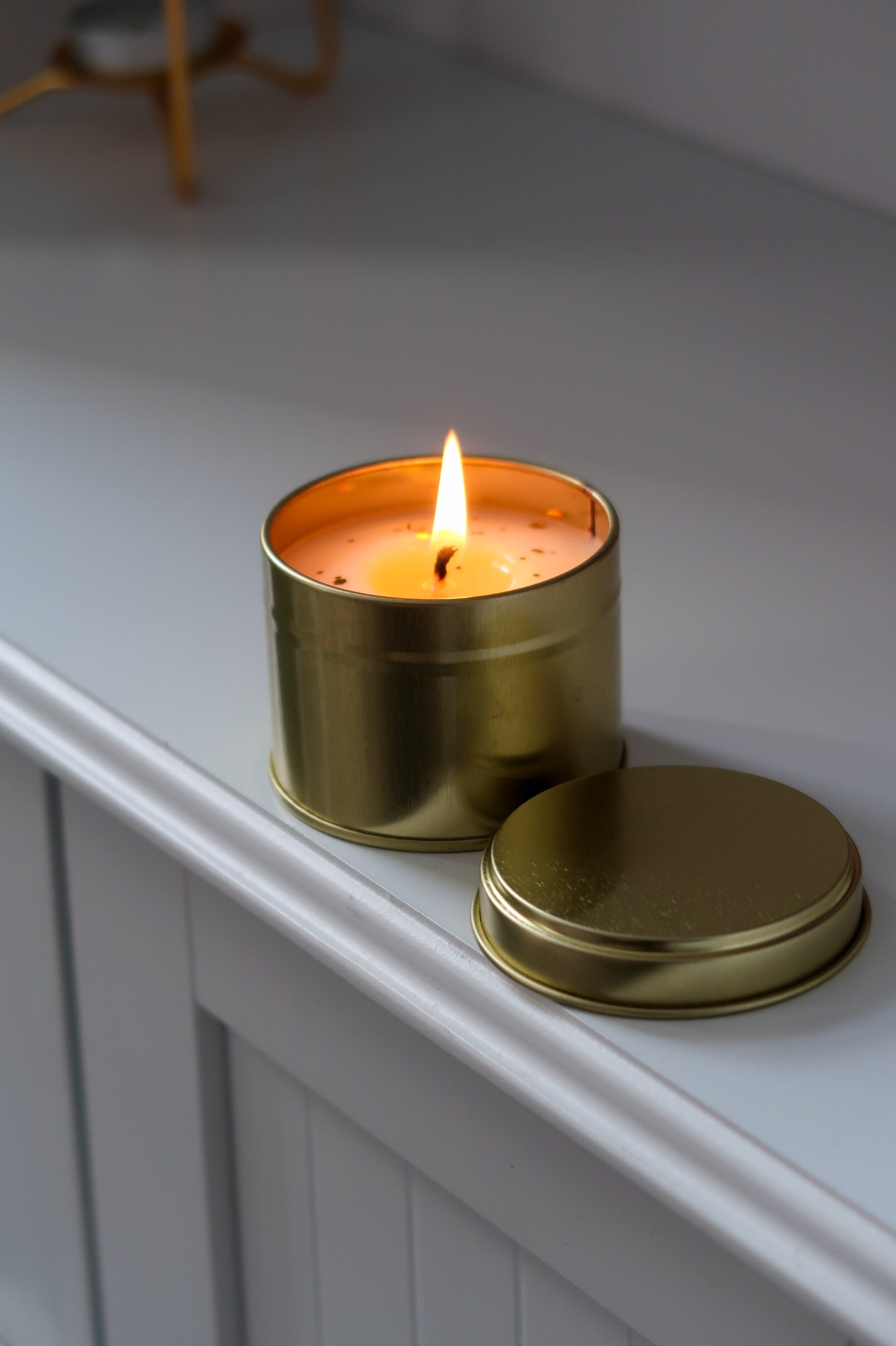 Assorted 100g Gold Tin Candles from a pack of 6, featuring various scents like Lavender and Rose Oud, crafted as elegant hand poured scented candles. Blank label candles, wholesale candles, white label candles.