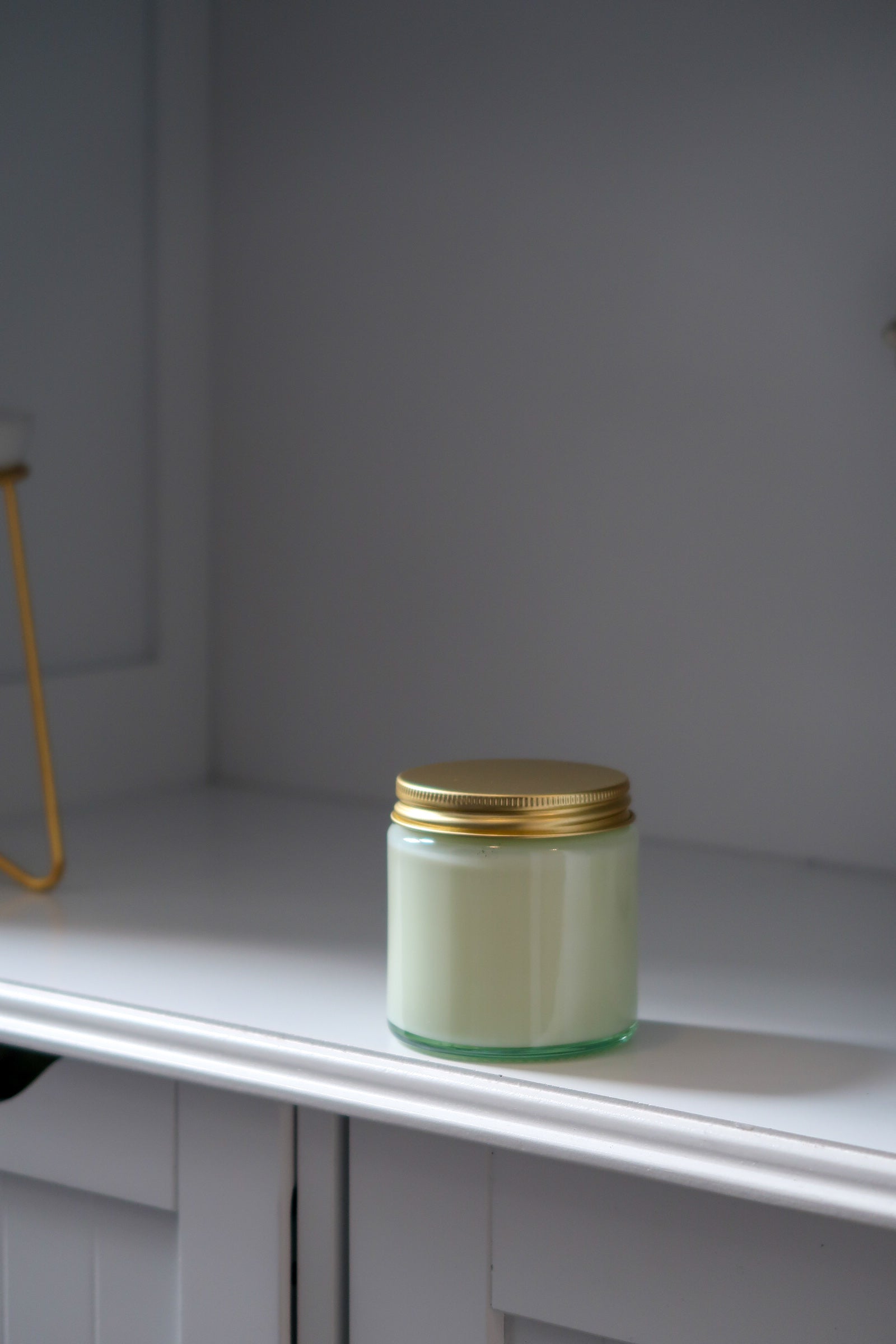 Unlit 120g Clear Glass Gold Lid Candle by Timeless Aromas Ltd, a charming addition to any space among the pack of 6 hand poured candles. This white candle, featuring a gold lid, serves as an elegant home fragrance option and makes a thoughtful gift. Great for wholesale, it comes with a blank label.