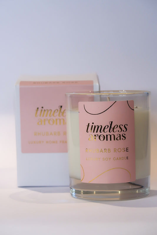 Timeless Aromas Rhubarb Rose Luxury Scented Candle, 200g, elegantly displayed with its packaging. Features a delicate floral design, showcasing the fruity-floral fragrance of rhubarb rose luxury scented candle.