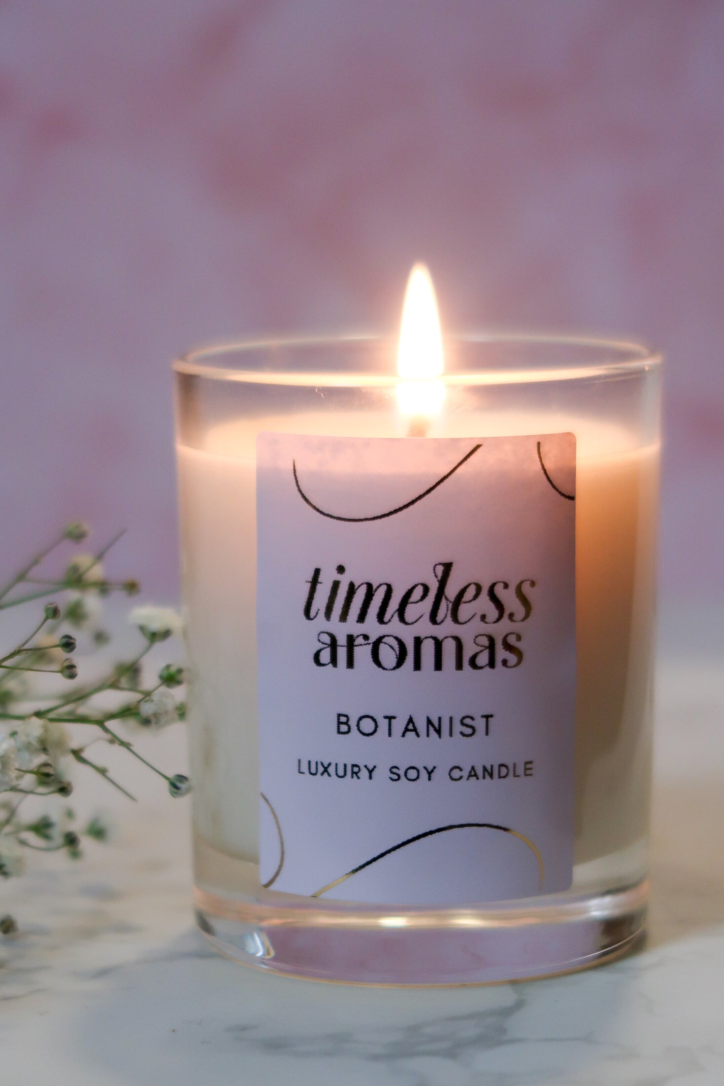 Close-up of Timeless Aromas Botanist Handcrafted Luxury Candle with a flickering flame, highlighting its premium quality.