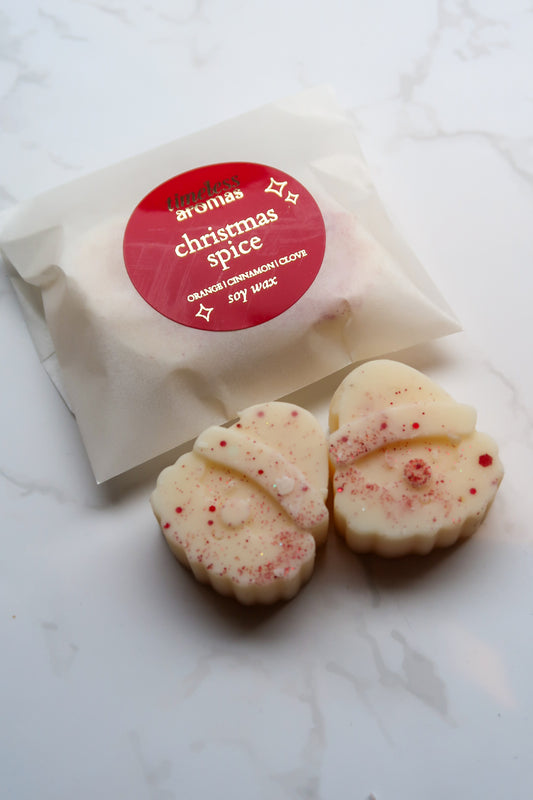 Elegant Christmas Spice Wax Melts by Timeless Aromas Ltd, showcasing two Santa-shaped soy wax melts in a beautiful recyclable glassine packet, perfect for festive gifting.