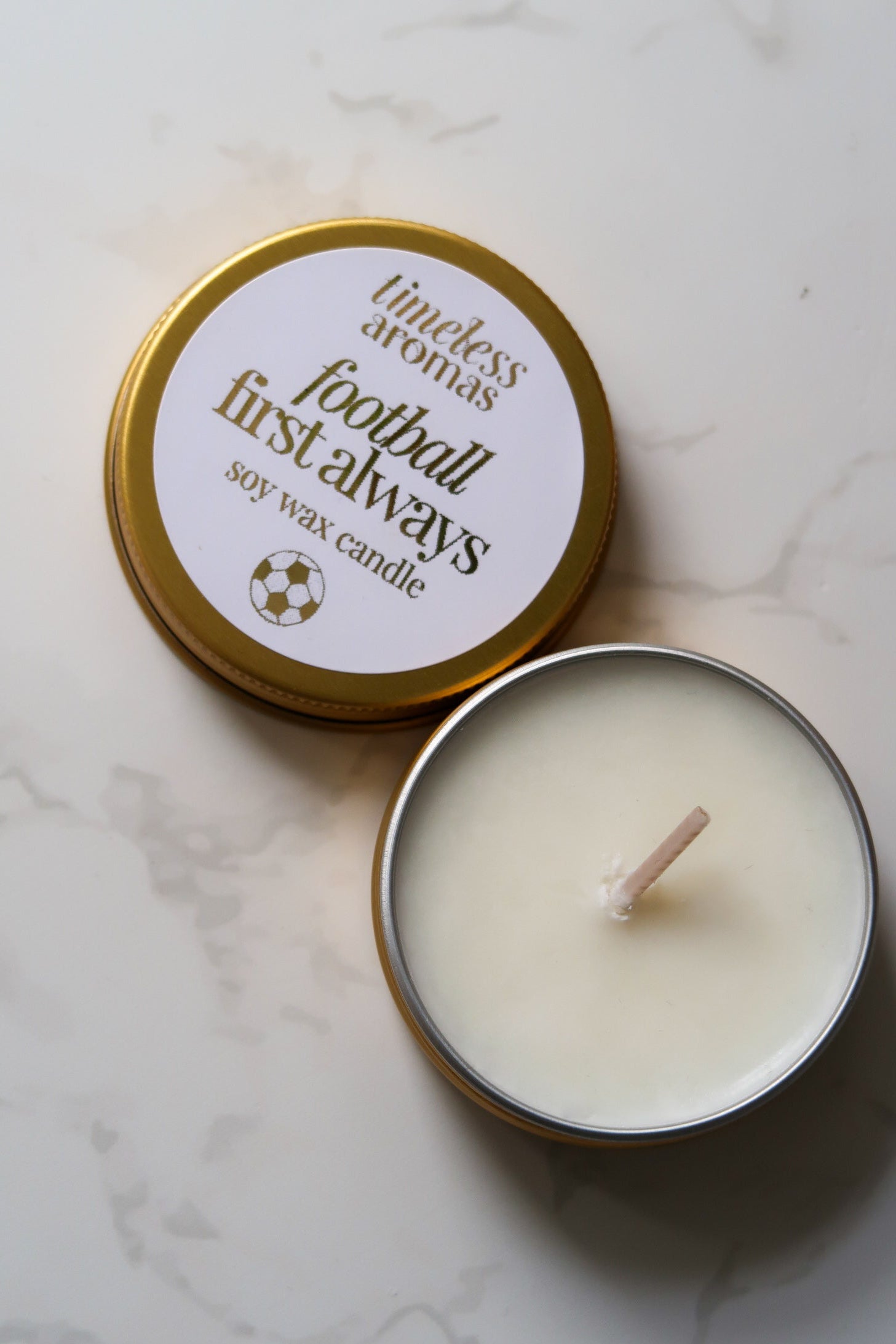 Timeless Aromas Ltd Football First Always Mini Gold Tin Candle in a stylish gold tin, perfect for football fans. Ideal for gifting on occasions like Father's Day or for celebrating the passion of Arsenal, Chelsea, or the England World Cup team. A luxurious choice for gifts for dad.