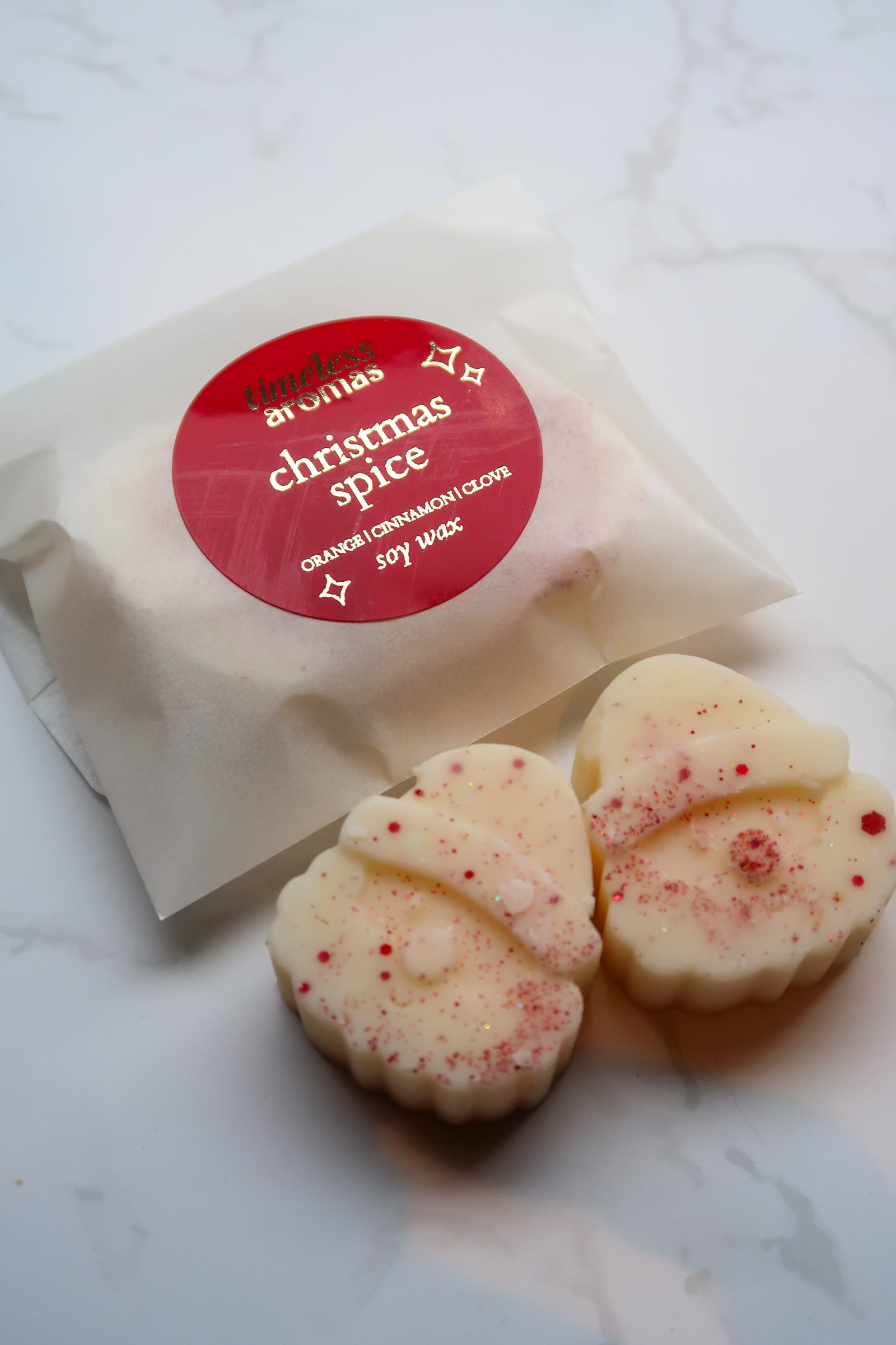 Refined presentation of Christmas Spice Wax Melts by Timeless Aromas Ltd, highlighting the delightful Santa melts alongside elegant packaging, perfect for the holiday season.