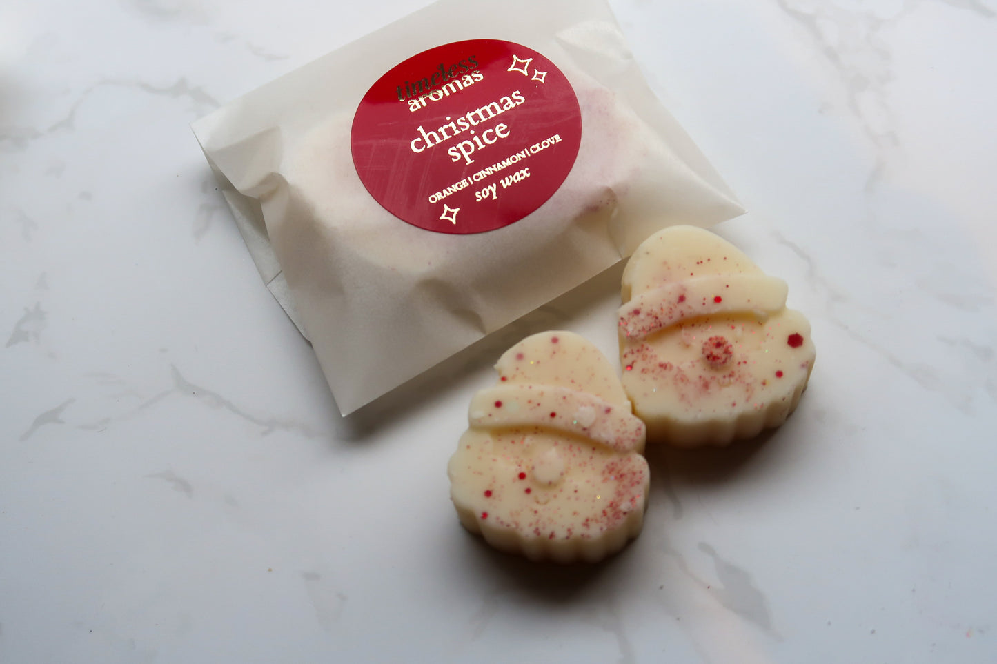 Sophisticated packaging of Christmas Spice Wax Melts by Timeless Aromas Ltd, featuring two Santa-shaped melts, ideal for a high-end festive gift experience.