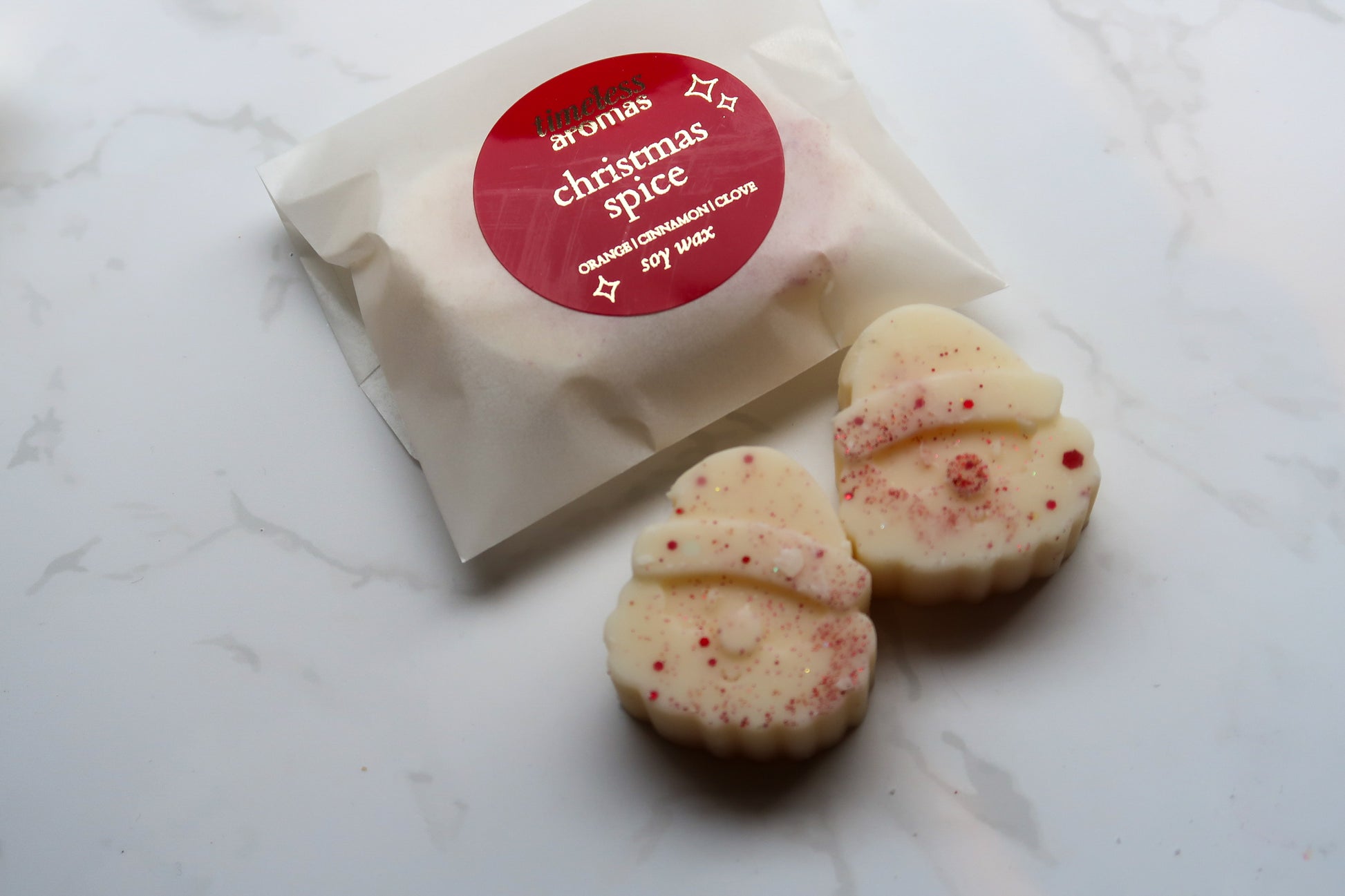 Sophisticated packaging of Christmas Spice Wax Melts by Timeless Aromas Ltd, featuring two Santa-shaped melts, ideal for a high-end festive gift experience.