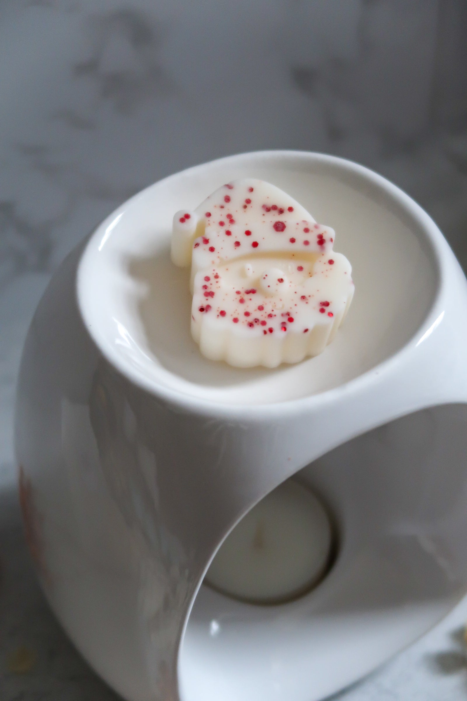 Luxurious Christmas Spice Wax Melt by Timeless Aromas Ltd, displayed on a stylish wax melt warmer, capturing the festive aroma of orange, cinnamon, and clove.