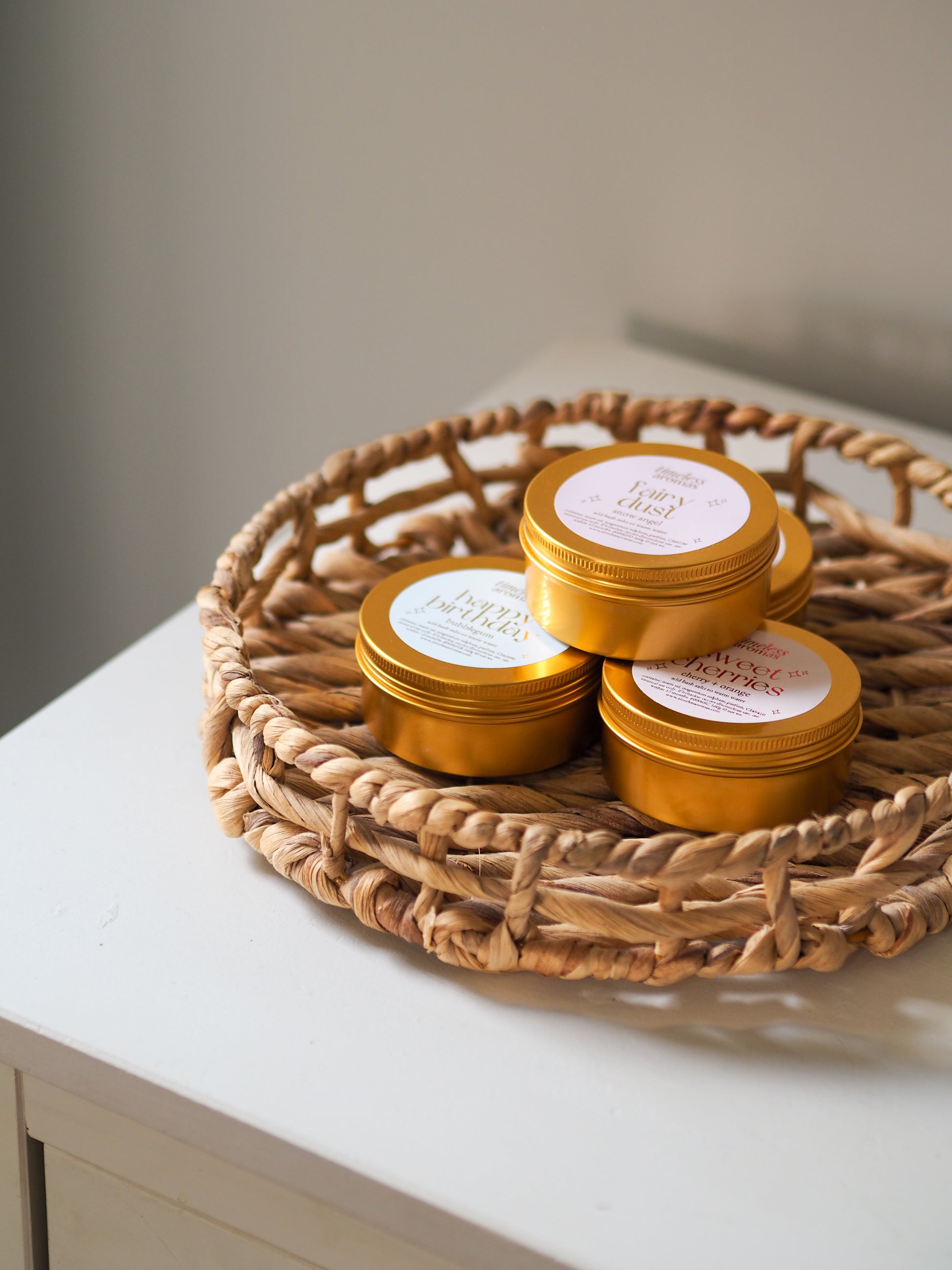 Happy Birthday Gold Tin Bath Salts by Timeless Aromas displayed in a lovely basket, emphasising the joyful experience of these bath salts for relaxation.