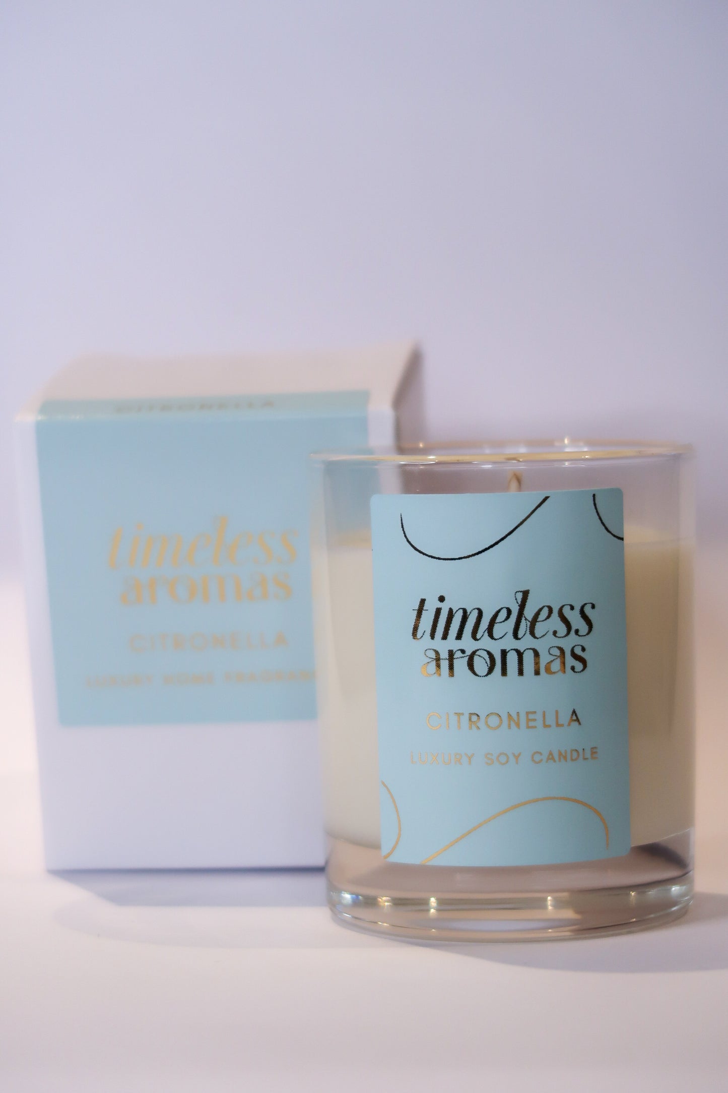 Citronella luxury candle by Timeless Aromas, elegantly presented in a glass container with a stylish label, perfect for enhancing outdoor spaces.