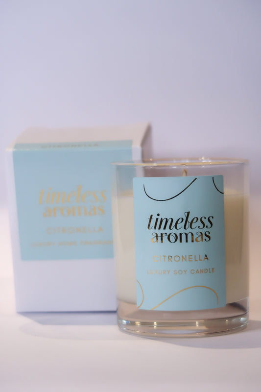 Citronella luxury candle by Timeless Aromas, elegantly presented in a glass container with a stylish label, perfect for enhancing outdoor spaces.