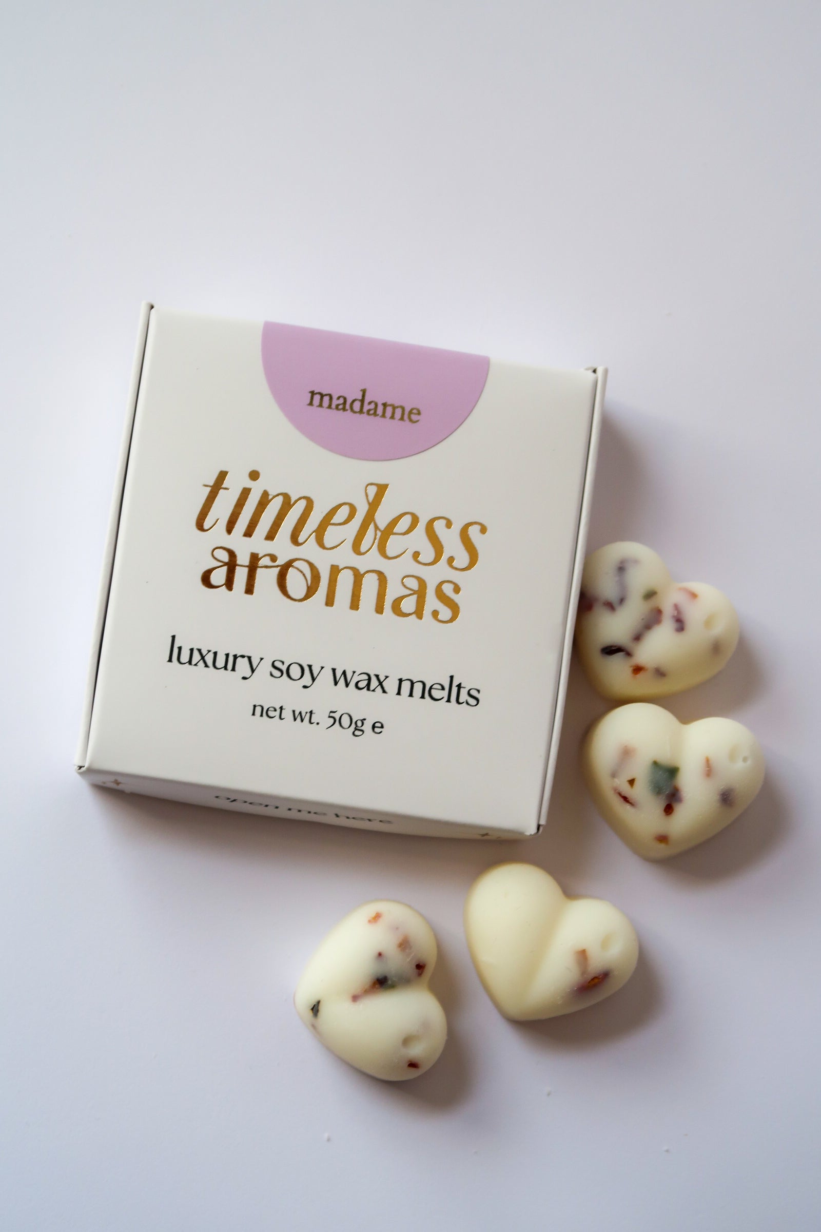 Madame Wax Melt Box featuring Timeless Aromas Ltd, showcasing white, botanical filled heart shaped wax melts with sparkling accents, ideal for filling your home with fragrance.