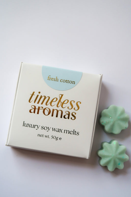 Timeless Aromas fresh cotton luxury wax melt box displayed on a white surface, perfect for creating a refreshing scent in your home. This box includes 50g of highly fragrant wax melts, ideal for gifting or personal use, featuring the delightful aroma of fresh cotton. Perfect for those who love a clean and refreshing scent, great for a faire atmosphere.