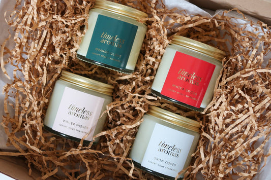Timeless Aromas Ltd Christmas Candle Gift Set featuring four luxury gold lidded candles including Christmas Spice, Winter Spices, Snow Kissed and Winter Wishes, perfect for adding festive fragrance to your home with these christmas scented candles.