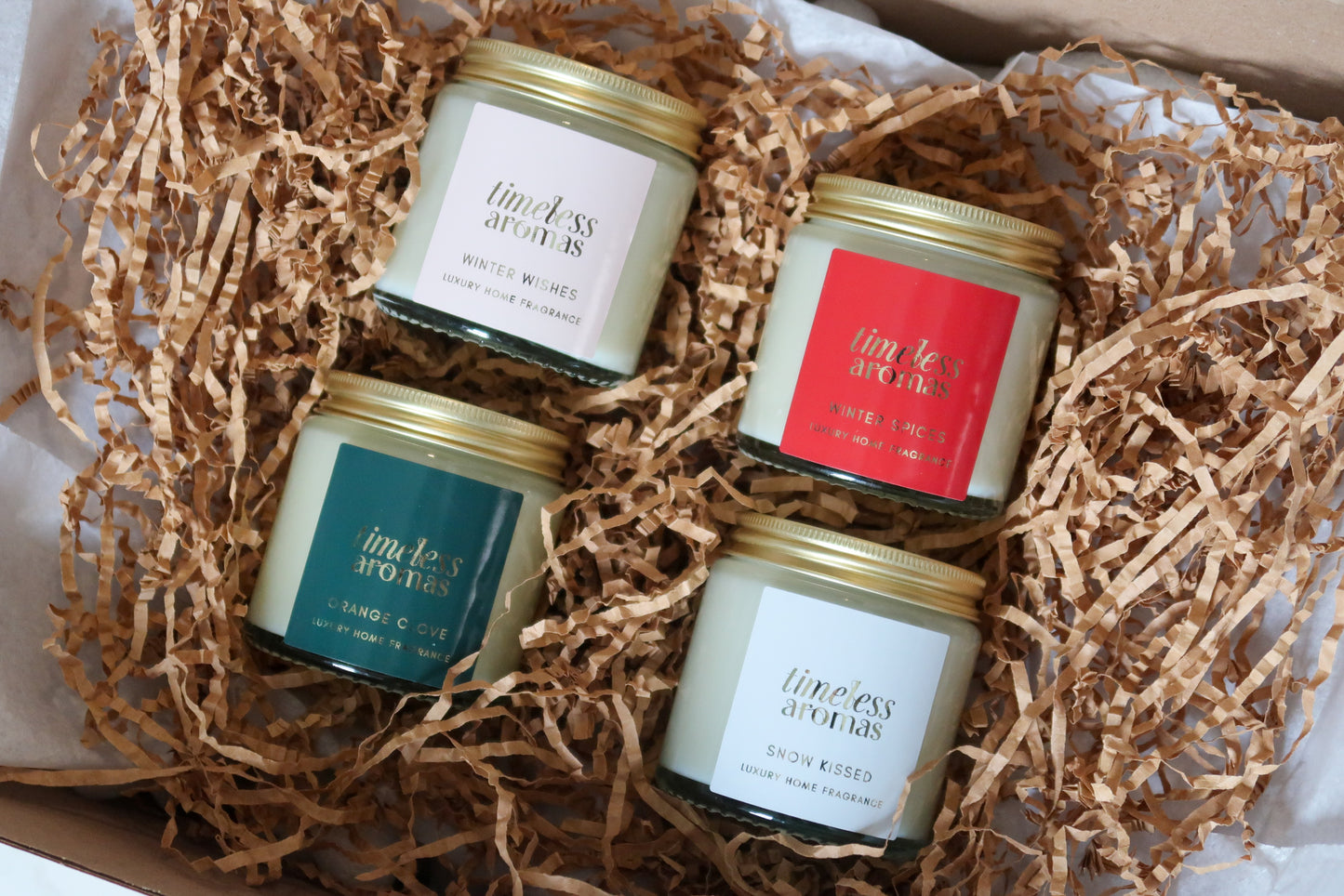 Timeless Aromas Ltd exquisite Christmas Candle Gift Set showcasing four beautifully hand poured candles, including Winter Wishes and Snow Kissed, designed for luxurious seasonal decor with delightful christmas scented candles.
