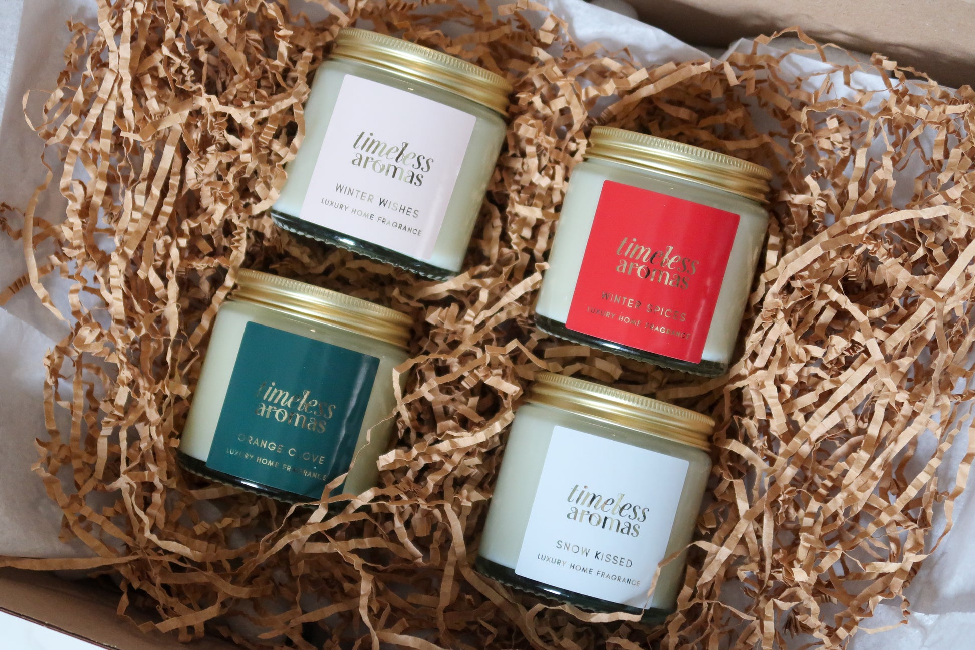 Timeless Aromas Ltd exquisite Christmas Candle Gift Set showcasing four beautifully hand poured candles, including Winter Wishes and Snow Kissed, designed for luxurious seasonal decor with delightful christmas scented candles.
