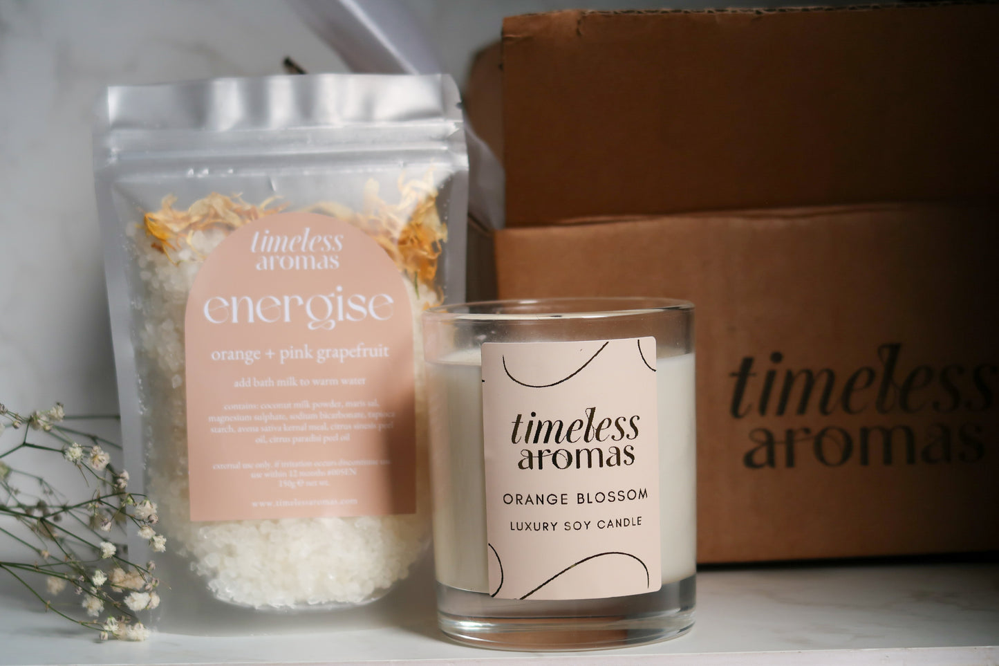 Timeless Aromas Bloom and Energise Gift Set arranged neatly with the candle and bath milk, ideal for creating a home fragrance set, featuring 200g of uplifting orange blossom and floral vibes.