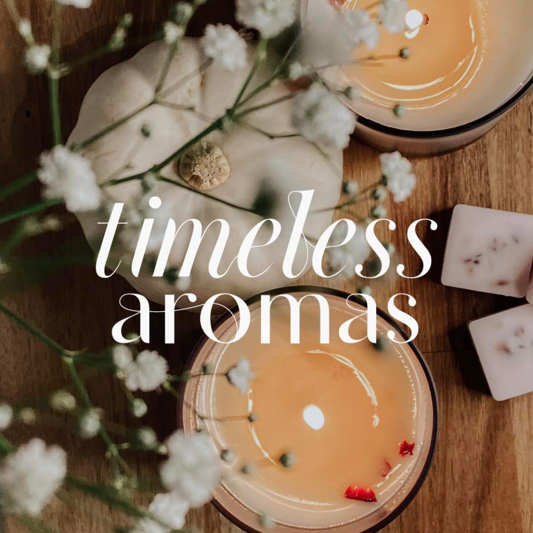 Stylish arrangement featuring candles, a decorative pumpkin, and flowers, promoting the Timeless Aromas E-Gift Card by Timeless Aromas Ltd. Perfect for gifting aromatic experiences.